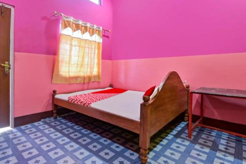 a bedroom with a bed in a pink room at Hotel O WELCOME RESORT & FAMILY RESTAURANT in Barpeta
