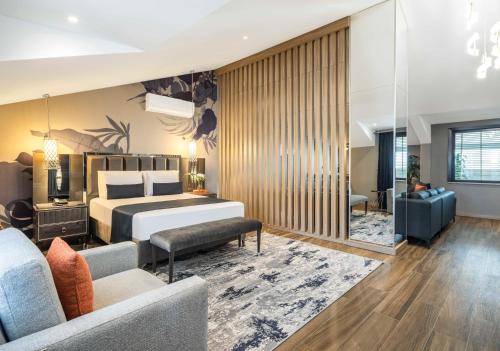 a bedroom with a bed and a living room at The Capri Hotel Osmanbey in Istanbul
