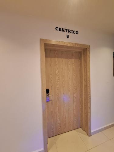 a wooden door in a building with a sign on it at Centrico 8 Tanger Bendiban in Tangier