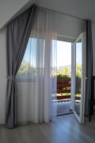 a room with a large window and a sliding glass door at Casa Bokor in Sovata