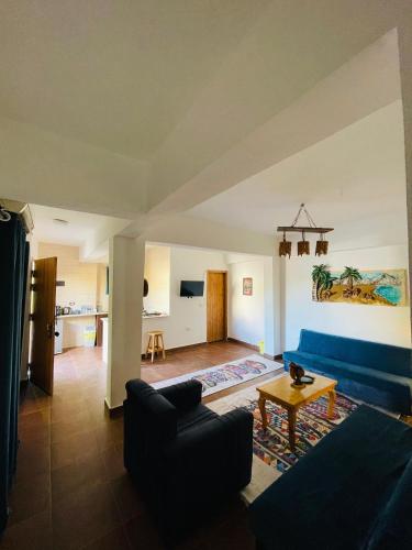 a living room with a blue couch and a table at Club Red Dahab Motel in Dahab