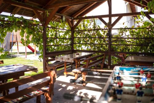 a group of picnic tables in a wooden pavilion at Casa Bokor in Sovata