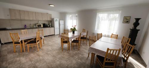 a kitchen and dining room with tables and chairs at Casa Bokor in Sovata