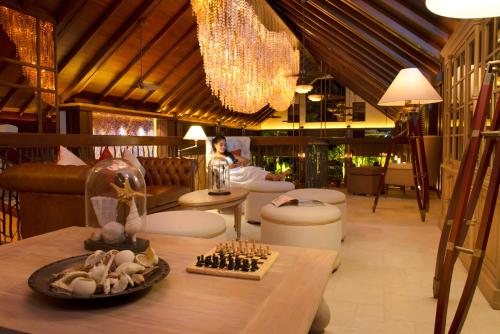 a living room with a chess set on a table at STORY Seychelles in Beau Vallon