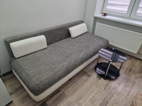 a bed in a room with a suitcase on the floor at Cozy apartments in the center of Liepaja in Liepāja