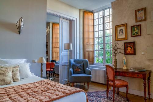 a bedroom with a bed and a desk and a chair at Appartement raffiné vue cathédrale, jardin, wifi in Tours