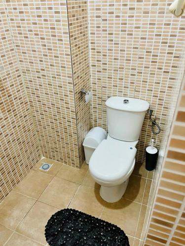 a bathroom with a white toilet in a tiled shower at Résidence cosy or in Douala