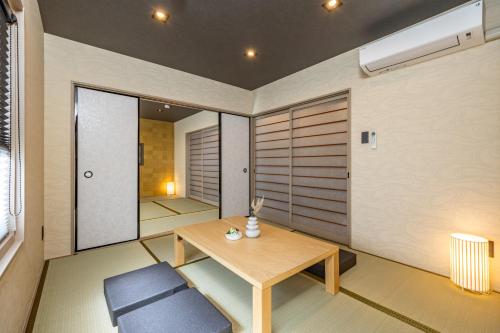 a small room with a table and a chair at JAPAVISTA Yamato in Osaka