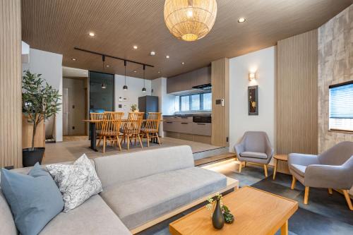 a living room with a couch and a table at JAPAVISTA Yamato in Osaka