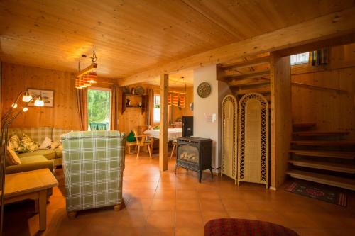 a living room with a couch and a stove at Alpendorf Dachstein West by ALPS RESORTS in Annaberg im Lammertal