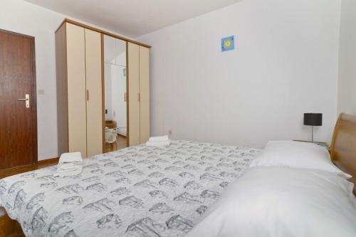 Postel nebo postele na pokoji v ubytování Apartments Ive