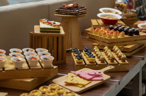 a display of different types of desserts and pastries at Doubletree By Hilton Shanghai Hongqiao in Shanghai