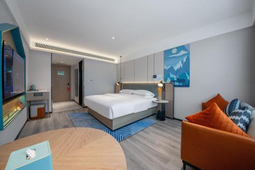 a hotel room with a bed and a couch at Echarm Hotel Potala Palace Da Zhao Temple Branch in Lhasa