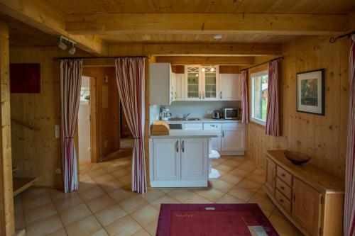 a kitchen with white cabinets and a counter top at Alpendorf Dachstein West by ALPS RESORTS in Annaberg im Lammertal