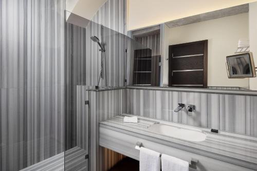 a bathroom with a sink and a mirror at DeCamondo Galata, a Tribute Portfolio Hotel in Istanbul