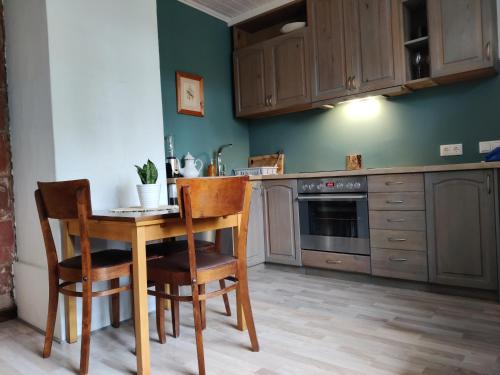 a kitchen with a table and chairs in a room at Suure terrassiga korter raudteejaama lähedal in Viljandi