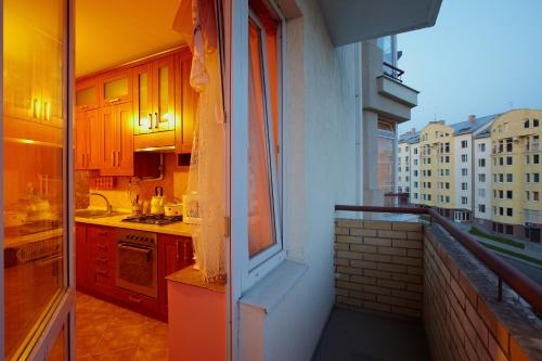 a kitchen with a stove top oven on a balcony at Апартаменти на Сихові 3й in Lviv