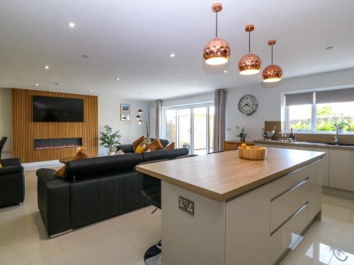 a kitchen and living room with a large island at Hedd in Amlwch