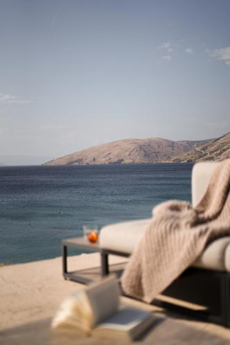 a couch sitting on the beach with a view of the ocean at Luxusvilla Marim in Stara Baška