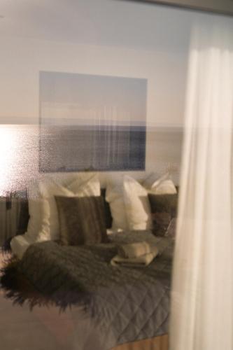 a living room with a couch with pillows at Luxusvilla Marim in Stara Baška