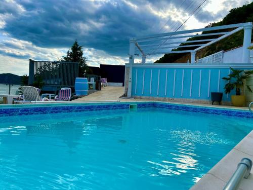 a swimming pool with blue water in a yard at Riviera 990 - Resort & Restaurant in Eşelniţa