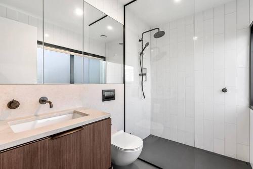a bathroom with a toilet and a sink and a shower at Skyfall - Luxury Country Retreat in Waimauku