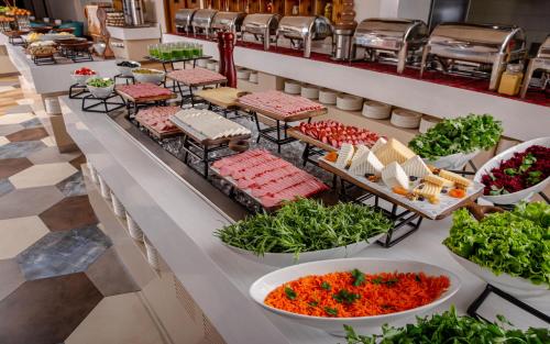 a buffet line with plates of food and vegetables at Lankaran Springs Wellness Resort in Lankaran