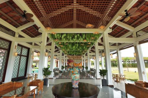 a lobby with a vase on a table in a building at SBH Gloria Hue in Hue