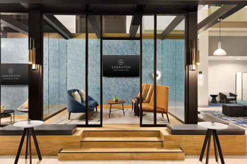 a rendering of a lobby with chairs and tables at Sheraton Suites Chicago O'Hare in Rosemont