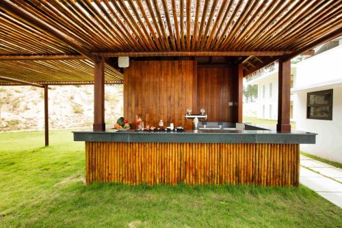 an outdoor kitchen with a wooden bar in a yard at SBH Gloria Hue in Hue