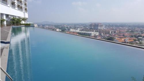 a swimming pool on the roof of a building at Silverscape SeaView Residences Melaka in Malacca
