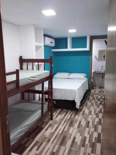 Habitación con 2 literas y pared azul en Kitnet contêiner climatizada, en Ubatuba