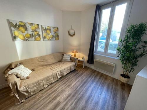 un salon avec un canapé et une fenêtre dans l'établissement Joli Studio RDC à 100m des plages, à Toulon