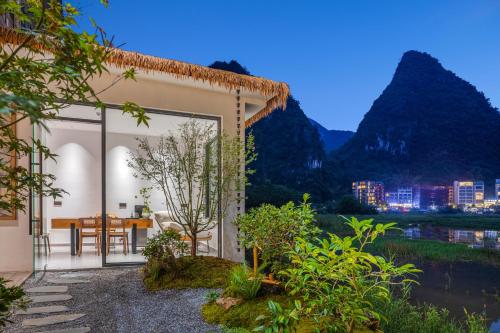 a house with a view of the mountains at Dyed Mount Boutique Hotel in Yangshuo