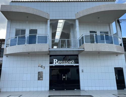 a white building with a retailer sign on it at renascer in Mauá