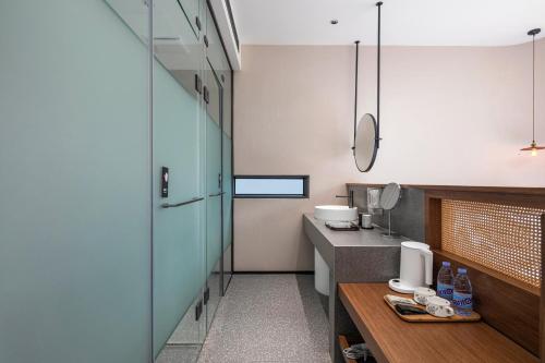 a small kitchen with a counter and a sink at Dyed Mount Boutique Hotel in Yangshuo