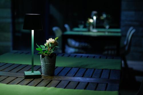 a table with a lamp and a flower on it at Saint George Palace Aparthotel in Bansko