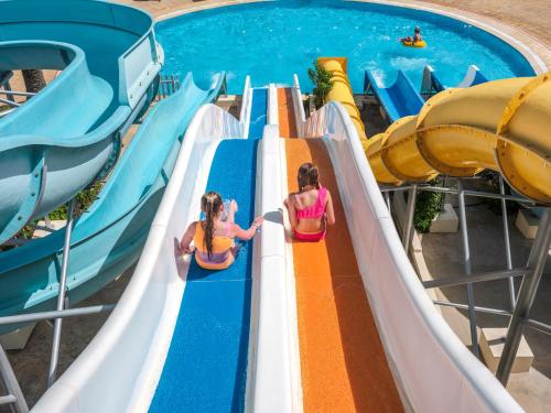 two girls on a water slide at a water park at TUI BLUE Manar in Hammamet