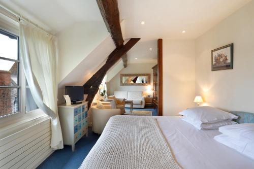 a bedroom with a bed and a living room at Auberge du Bon Laboureur Chenonceaux in Chenonceaux