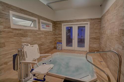 a hospital room with a bath tub and a window at Colonial Motel and Spa in Brattleboro