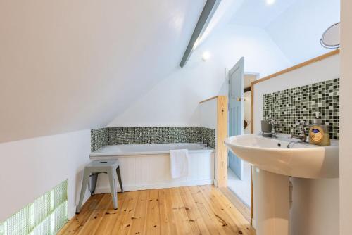 a bathroom with a sink and a toilet in it at Nyth Y Wennol in Brynsiencyn