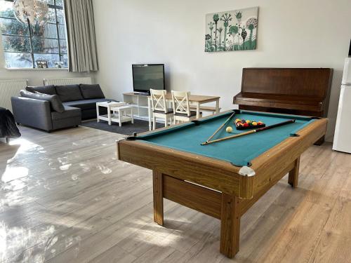 a living room with a pool table and a couch at Monumental independent Studio, City Centre Dordrecht in Dordrecht