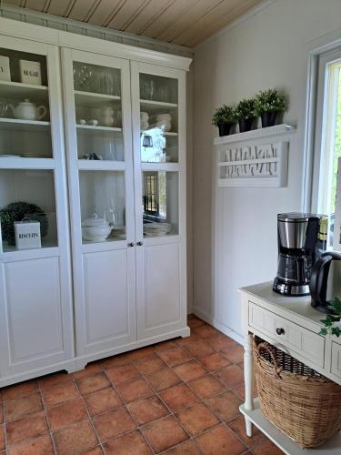 a kitchen with white cabinets and a table at Østby Trysil luxury holiday home in Trysil