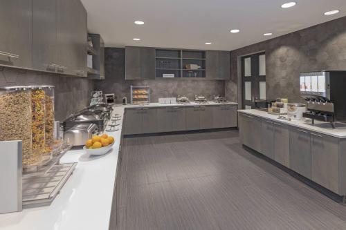 a large kitchen with a counter with oranges on it at Residence Inn by Marriott Halifax Dartmouth in Halifax
