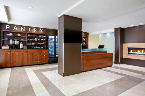 a room with a pantry with a fireplace at Four Points by Sheraton Surrey in Surrey