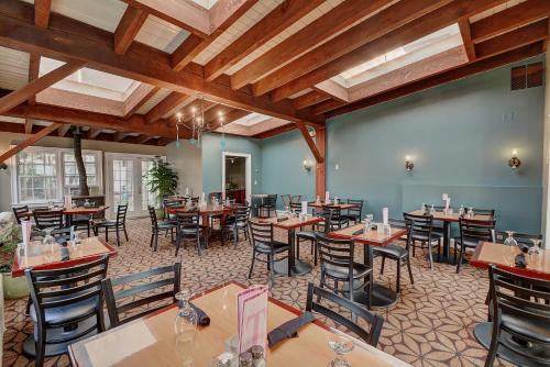 a restaurant with tables and chairs in a room at Colonial Motel and Spa in Brattleboro
