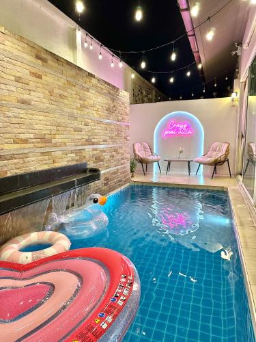 a swimming pool with a duck in a spa at Cazy pool villa pattaya in Jomtien Beach