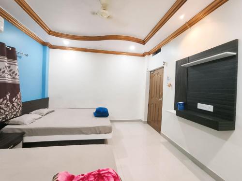 a room with two beds and a fireplace at shree trilokeshwar Mahadev guesthouse in Ujjain