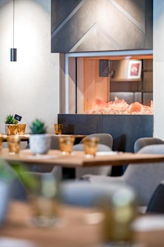 a restaurant with a table with some food on it at Ruhpoldinger Hof - Hotel & Wellness in Ruhpolding