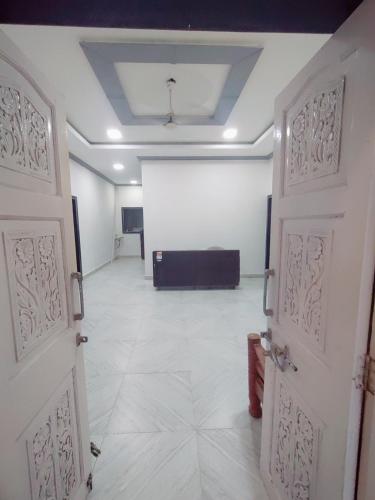 an empty room with two doors and a stage at Hotel seafront in Murud